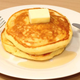 Stack of pancakes on white plate